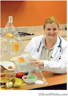 A nurse at 11th Street Family Health Services uses the food pyramid to educate patients about a healthy diet.